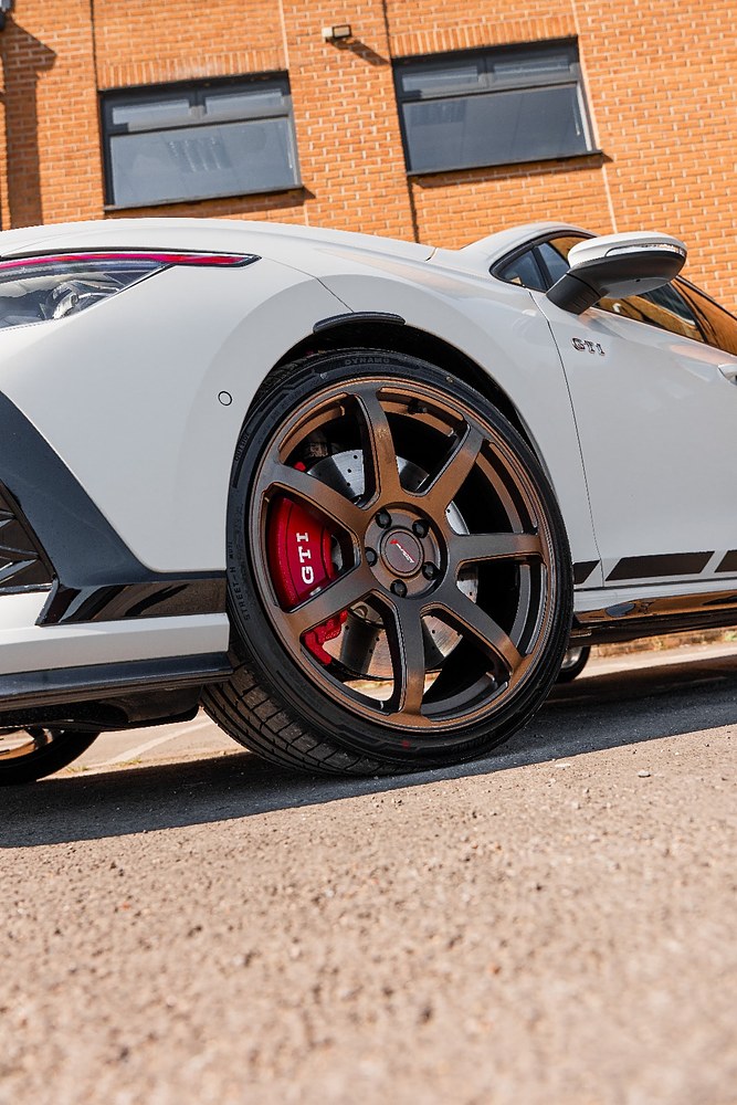 Bronze alloy wheel fitted to a white GTI hot hatch